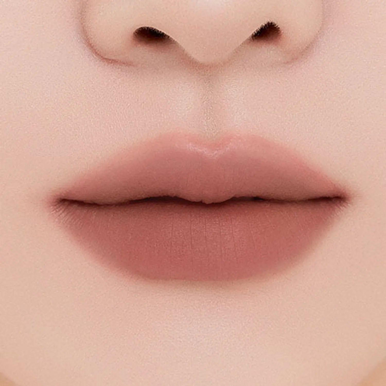 MUZIGAE MANSION Tie Up Cover Tint in sculpted knot tube with soft matte mousse formula. Shade faded fig