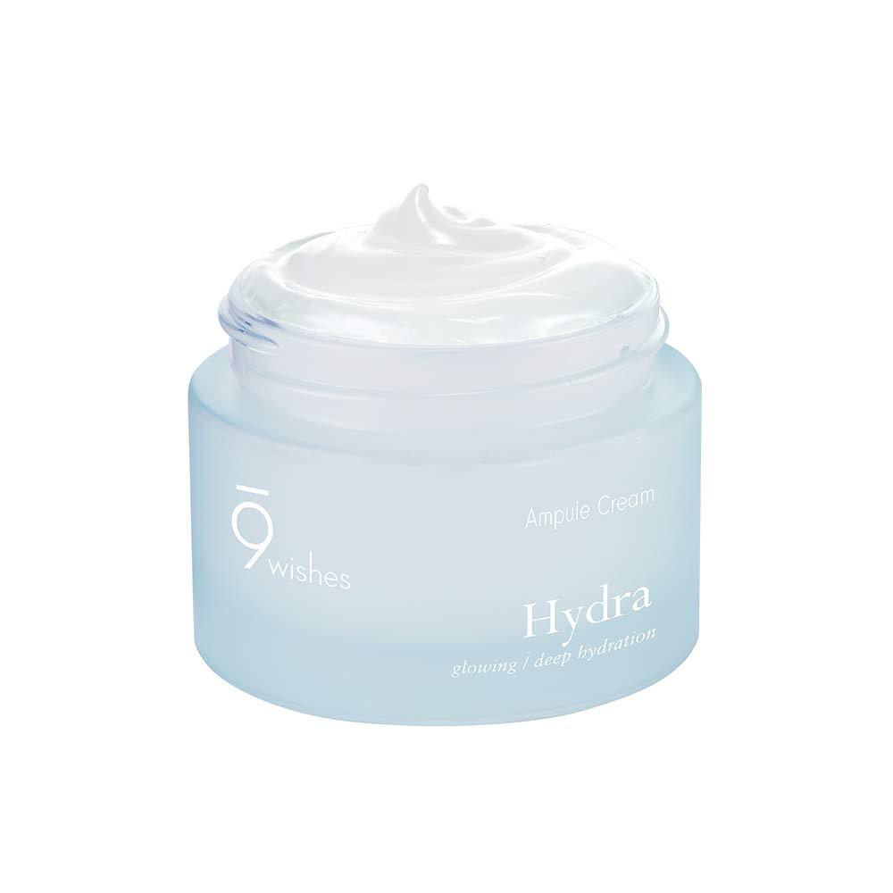 A jar of 9wishes Hydra Ampule Cream with a clear gel cream texture, predominantly in a light blue to white color range, with a silver lid.
