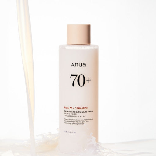 Anua Rice 70 Glow Milky Toner bottle with rice grains and milky liquid, showcasing Korean skincare hydration and brightening benefits.