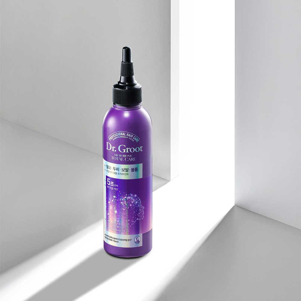 A bottle of Dr.Groot Microbiome Ampoule Treatment designed for hair loss and scalp care, with a purple label and cap.