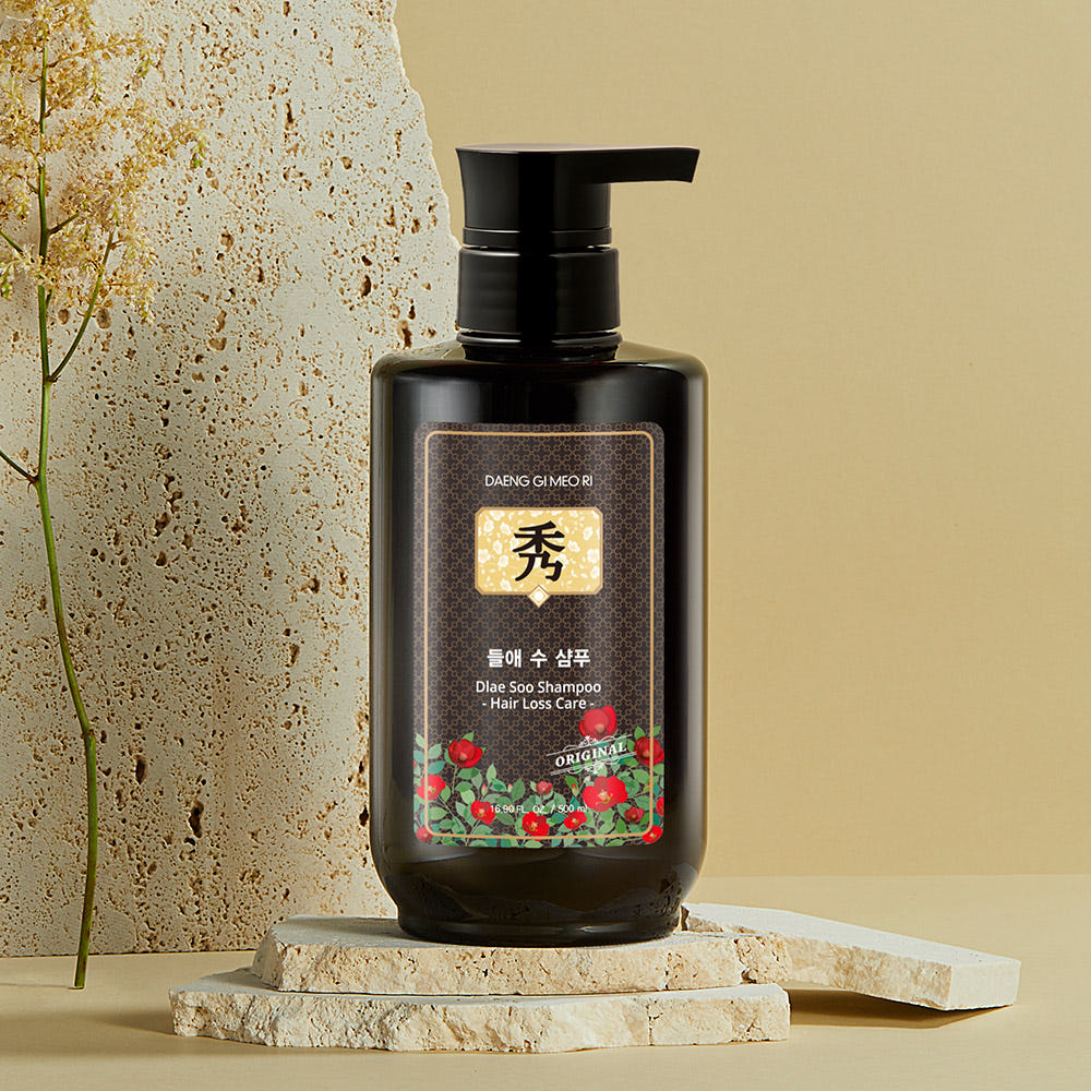 Dark bottle of Daeng Gi Meo Ri hair loss shampoo with herbal-themed design, gel texture for Korean scalp care