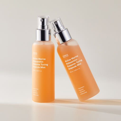 Astaxanthin Ampoule Mist bottle with coral-pink liquid on white background