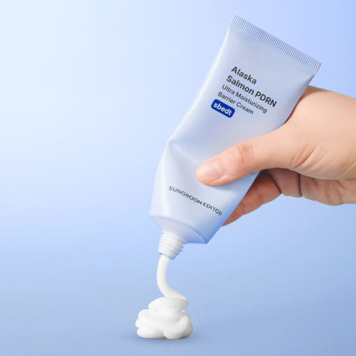 Tube of Alaska Salmon PDRN Ultra Moisturizing Barrier Cream on a blue background